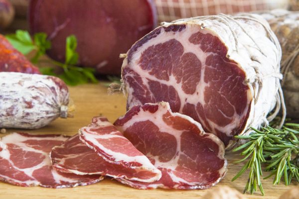 sliced capocollo sitting on a table top
