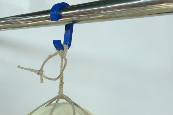 plastic hook clipped to rod to hang salami